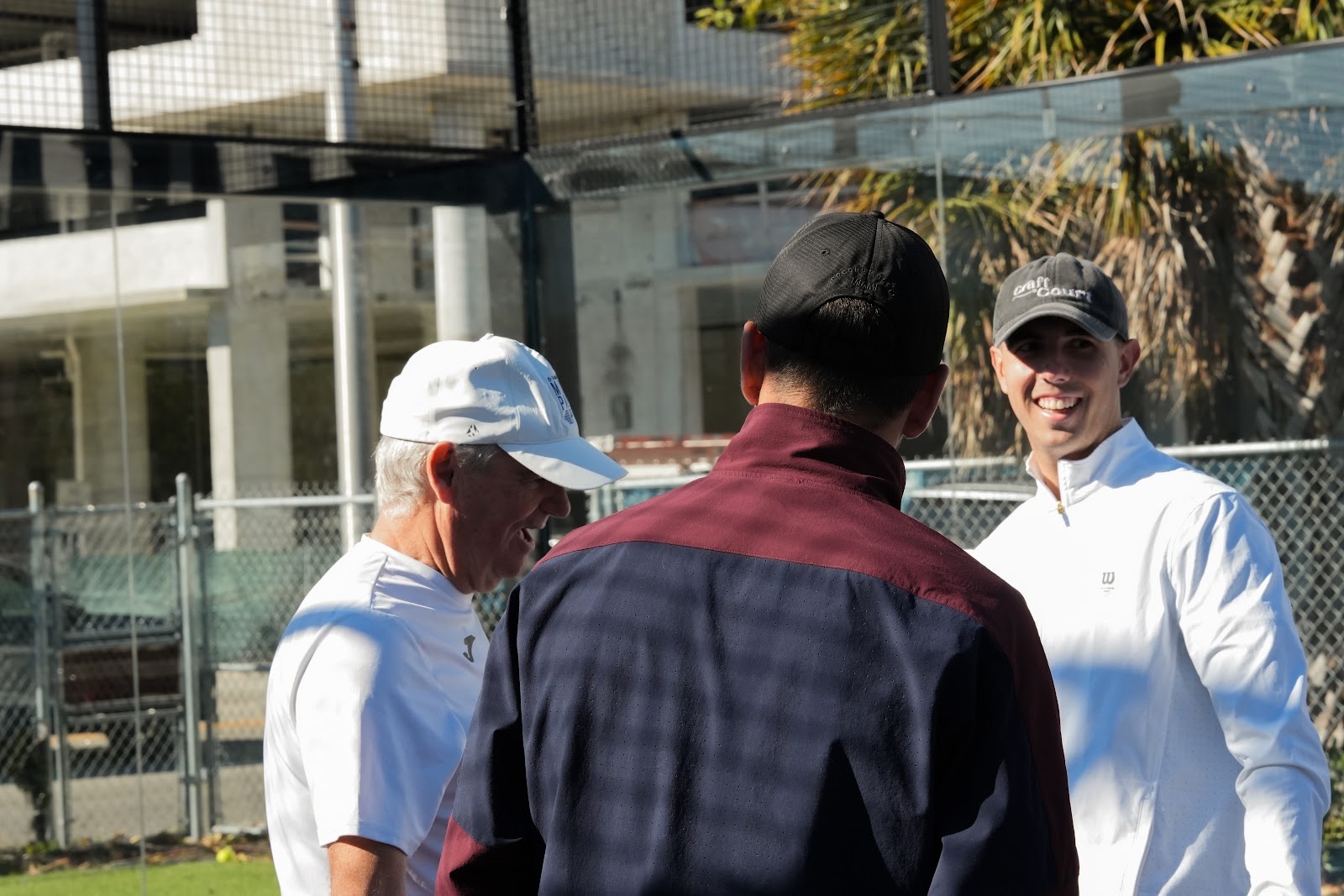 PadelEdge Academy players laughing together between points